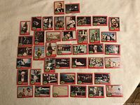 Photo showing the full set of 42 Star Wars collectible cards arranged on a flat light surface, each card featuring a red border and images from the Star Wars movies.