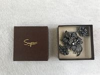 Vintage floral rhinestone brooch and clip-on earrings displayed inside a Simpsons branded brown box with gold logo.