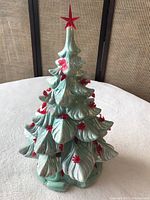 Front angle of vintage green ceramic Christmas tree with red bulbs and star