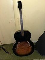 Full front view showing sunburst body, F-holes and neck