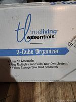 Box showing TrueLiving Essentials 3-Cube Organizer branding and product details.