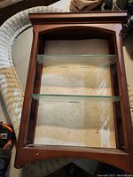 Top view showing wooden frame and glass shelves inside.