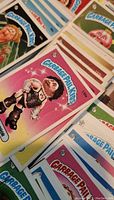 Multiple Garbage Pail Kids cards fanned out displaying various characters and border colors
