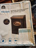 Photo of the box with product branding and images showing the mailbox model, finish, and features like rust resistance, medium capacity, and key lock.