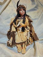 Full view photo of the Native American porcelain doll in its outfit