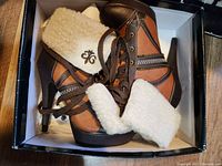 Top view of the vintage women's high heel shoes with shearling collar in the box.