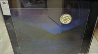 Full view of framed indigenous art showing nighttime landscape and moon symbol with tag visible