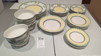Full view of stacked dinner plates, salad plates, bread plates, and bowls in the Villeroy & Boch French Garden Fleurance pattern showing the pattern and quantity of items.