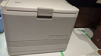 Front view of Igloo Koolmate 120 electric cooler showing the model label and latch