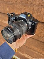 Canon EOS 650 35mm film camera front view with Canon AF Zoom 35-80mm lens, showing camera model and lens details.