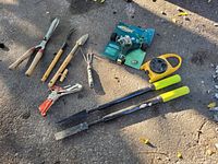 Garden tools including hand log splitters, handheld gardening tools, pruning saw, and sprinkler timer