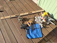 Overview of various home tools including spirit level, saw, clamp, electric fan, plastic hangers, and saw blades pouch