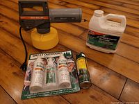 Full contents of mosquito fogger and insect repellent lot assembled on wooden floor showing all items.