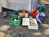 Overview of miscellaneous items including crates, shelving unit, and garden hose holders on ground.
