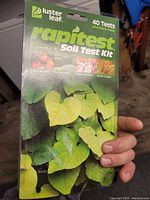 Front of soil test kit packaging showing brand Luster Leaf Rapitest Soil Test Kit with 40 tests and plant images