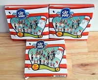 Three unopened boxes of Cat In The Hat Christmas ornaments, showing front packaging with characters and number of ornaments inside.