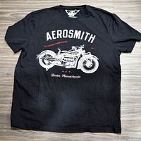 Front view of black Aerosmith XXL T-shirt showing white motorcycle graphic and text.