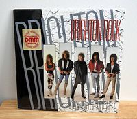 Front cover image of Brighton Rock 'Young Wild and Free' vinyl LP album showing band members and album title.