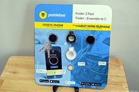 Front view of Pebblebee Finder 2 Pack package featuring two key and phone finders with a smartphone app interface shown, displayed on a stand.