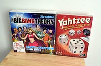 Photo of two boxed games: Big Bang Theory Fan Edition Fact or Fiction trivia game and Yahtzee dice game, both new.