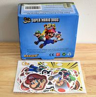 Box labeled 3D Super Mario Bros with stickers in front