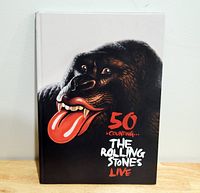 Front cover of the hardcover book showing a stylized gorilla head with the tongue logo and title text.