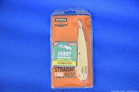 Front view of sealed Utopia Care straight edge razor with 100 Derby blades in blister packaging.