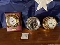 All three clocks displayed on table with American flag background