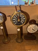 Front view of engine order telegraph showing dial face and pedestal