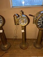 Full view of brass telegraph on pedestal, adjacent instruments visible.