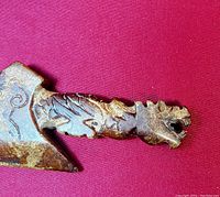 Close-up image showing the detailed dragon head and scaled handle carved from hard stone.