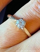 Close-up of diamond solitaire ring on finger