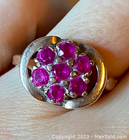 Close-up front view of ring showing seven ruby stones