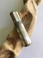 Full view of closed lighter showing mother of pearl panels and silver detailing.