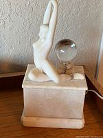 Full view of the Art Deco marble sculpture lamp featuring a female figure atop a rectangular alabaster base with silver accents and a crystal orb.