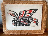 Front view of acrylic Raven painting on canvas mounted on woven cedar bark mat