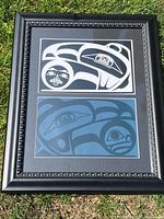 Frontal view of entire black ornate frame with two Raven prints