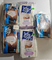 Photo showing five packages of Just My Size women's panties, all size 10, including 3-pack cotton panties and full brief packages in sealed plastic.