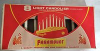 Original red and white box for the 8 Light Candolier marked Paramount with vintage graphics and product labeling.