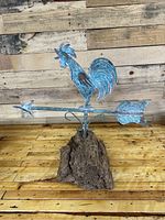 Full view of the rooster weathervane mounted on a rough driftwood piece showing overall size and condition.