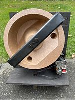 Top view of Leslie tremolo speaker unit showing large wooden drum and attached black metal arm.