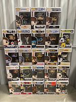 Photo of 24 Funko Pop figures stacked in their boxes against a storage unit door.