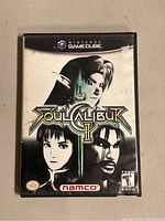 Front cover of Nintendo GameCube game Soul Calibur II in original plastic case showing cover artwork with characters and branding.