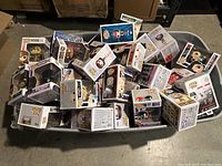 Large bib plastic bin full of Funko Pop! vinyl figure boxes stacked haphazardly with several labels, colors, and characters visible.