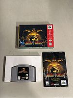 Full lot including Mortal Kombat 4 game cartridge for N64, original box, and instruction manual.