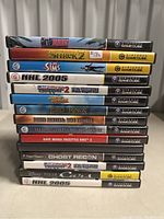 Stack of 15 Nintendo GameCube game cases showing titles