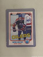 Front of card in plastic toploader showing Wayne Gretzky in Edmonton Oilers uniform