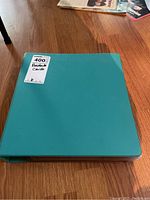 Teal binder labeled 'Baseball Cards' containing the trading cards.