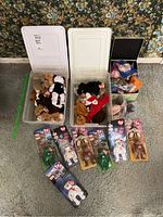 Three plastic storage bins: two containing loose TY Beanie Babies, one holding McDonald’s co-branded Happy Meal plush