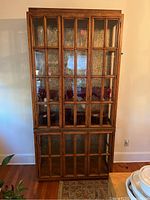 Full front view showing two-tier design with upper and lower glass-paneled doors